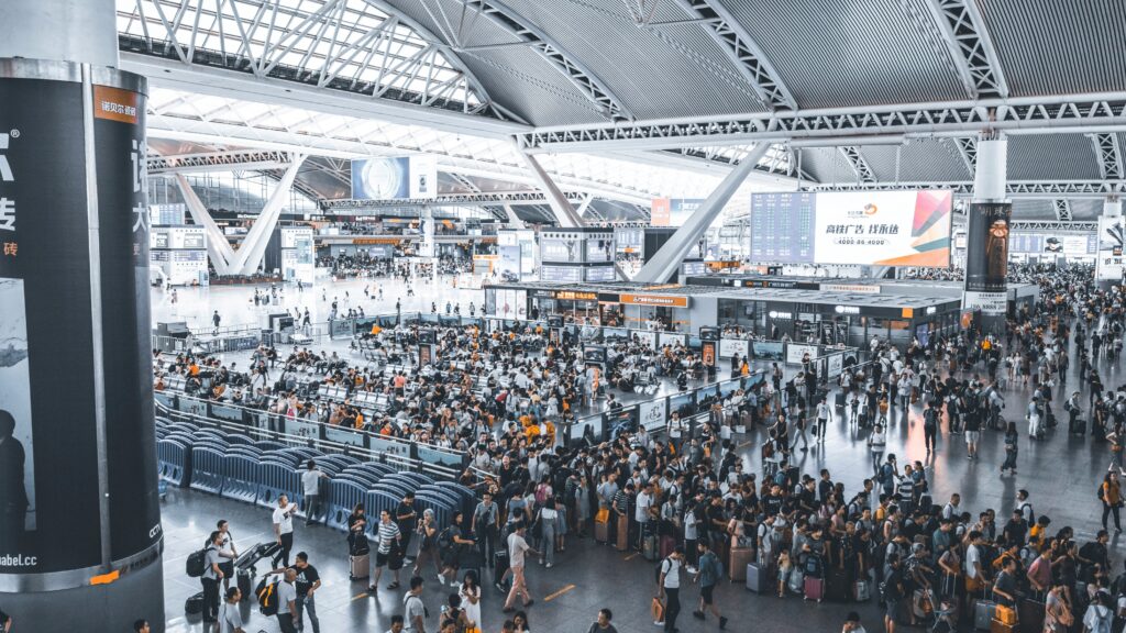 Interior view of an airport crowded with passengers