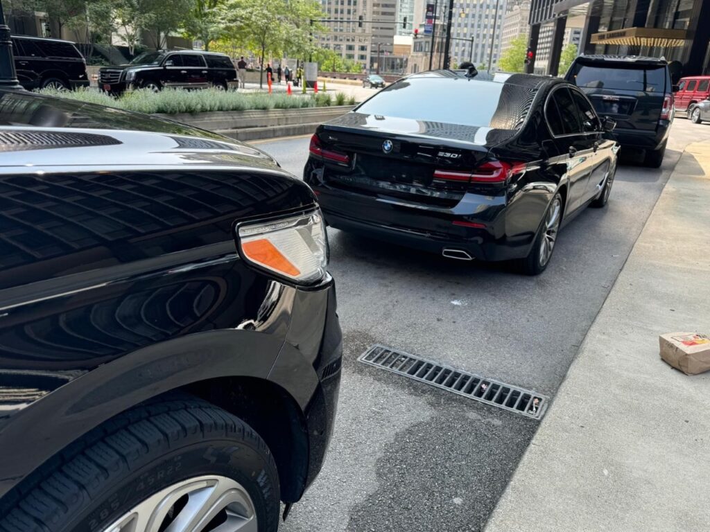 A Black luxury sedan on the road
