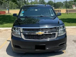 Our Luxury Chevy Suburban stands outside a garden