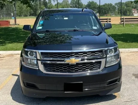 Our Luxury Chevy Suburban stands outside a garden